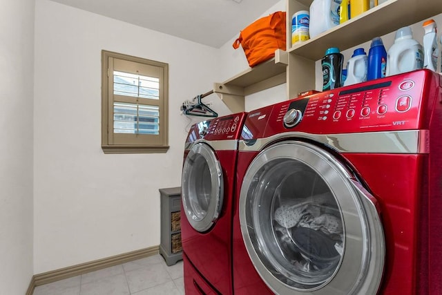 laundry room with baseboards, washer and dryer, tile patterned flooring, and laundry area