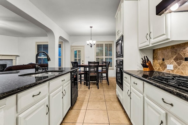 14208 Rising Star Blvd, Frisco, TX 75033 - kitchen with a sink, under cabinet range hood, a chandelier, black appliances, and white cabinetry