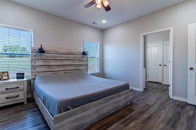 bedroom featuring baseboards, a ceiling fan, visible vents, and dark wood-style flooring