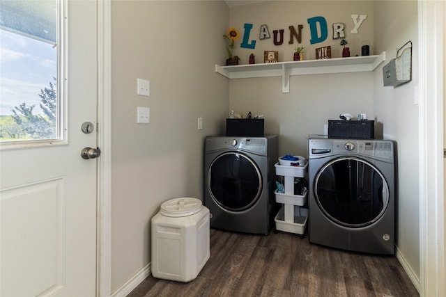 washroom with dark wood finished floors, washing machine and dryer, a healthy amount of sunlight, and laundry area
