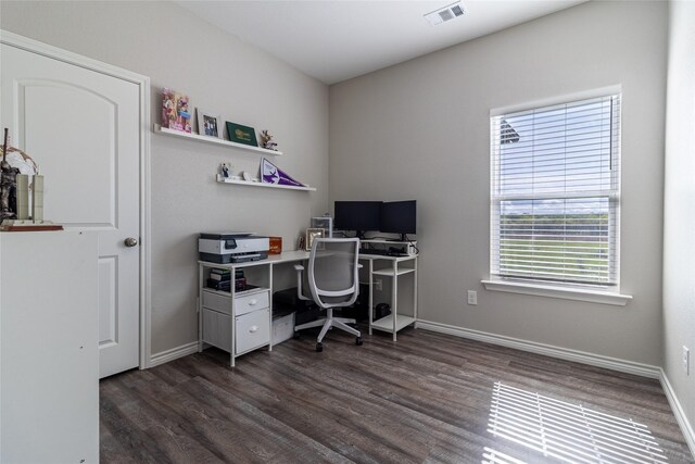 office space with baseboards, dark wood-style flooring, and visible vents