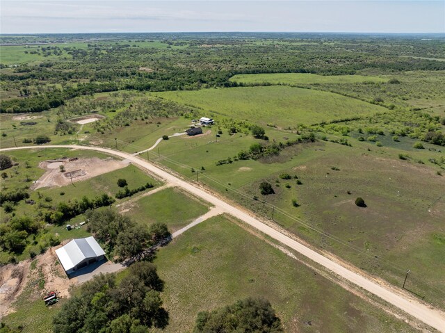 birds eye view of property with a rural view