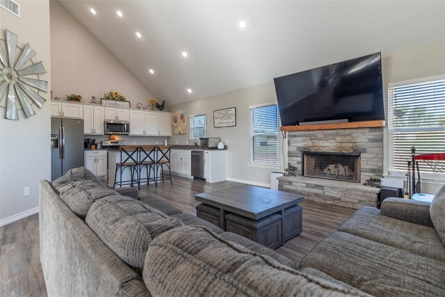 living area with recessed lighting, high vaulted ceiling, baseboards, and dark wood-style floors