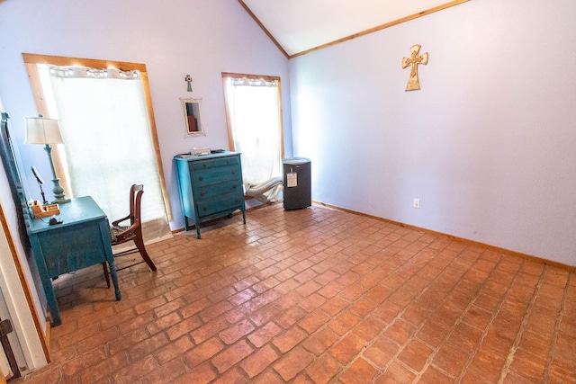 office featuring plenty of natural light, lofted ceiling, brick floor, and baseboards