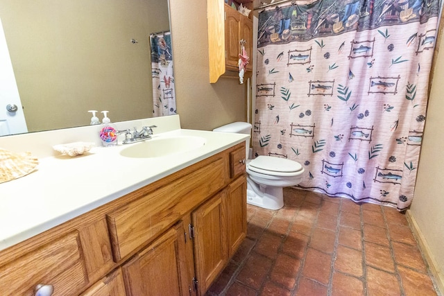 bathroom featuring vanity, curtained shower, and toilet