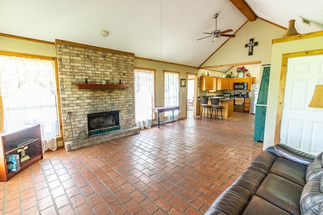 living area with brick floor, vaulted ceiling with beams, ceiling fan, a brick fireplace, and visible vents
