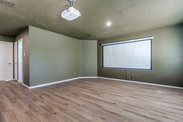 4504 Courtside Dr, Mckinney, TX 75070 - spare room featuring a textured ceiling, wood finished floors, and baseboards