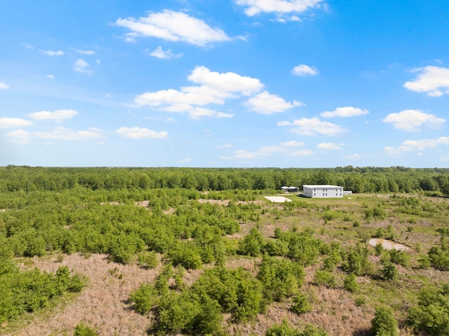 birds eye view of property with a wooded view