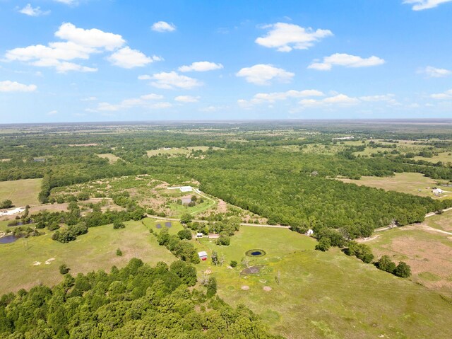 birds eye view of property featuring a forest view