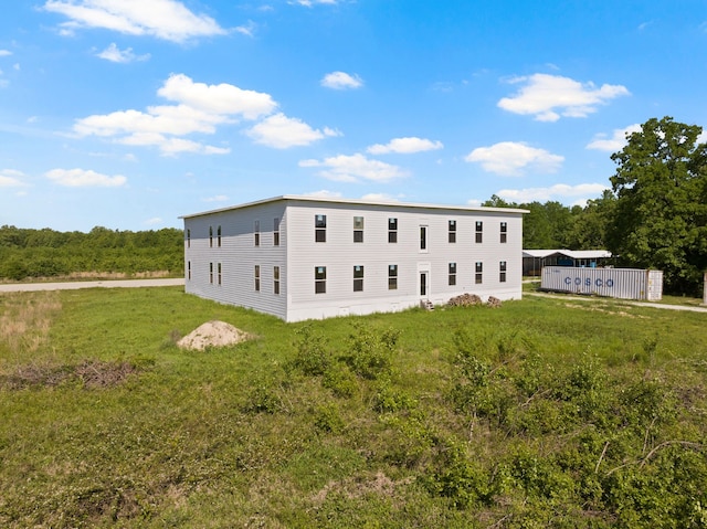 view of side of property with a yard