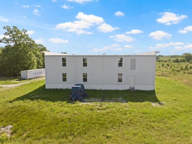 rear view of house with a yard