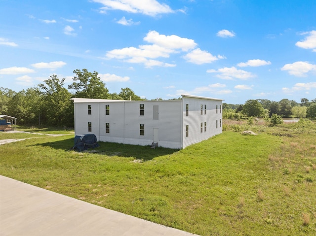 view of property exterior with a lawn