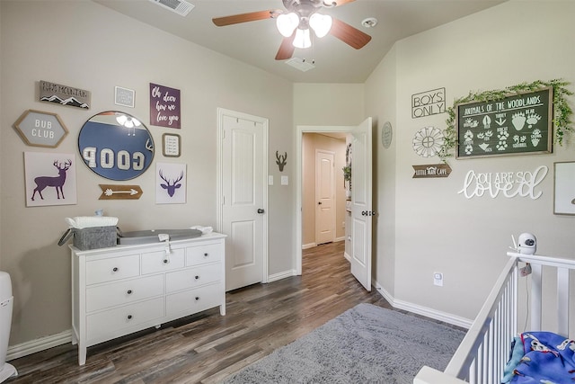 bedroom with visible vents, baseboards, ceiling fan, and dark wood finished floors