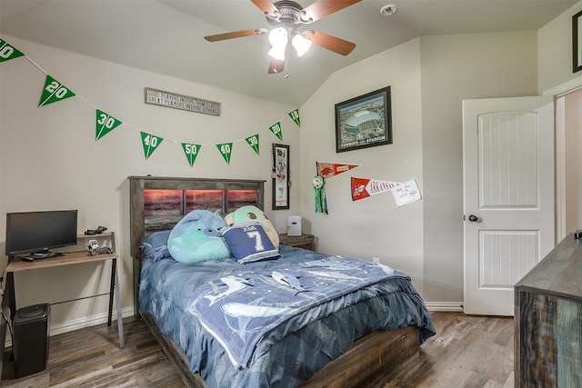 bedroom featuring ceiling fan, lofted ceiling, baseboards, and wood finished floors