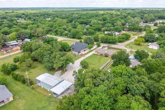 drone / aerial view with a wooded view