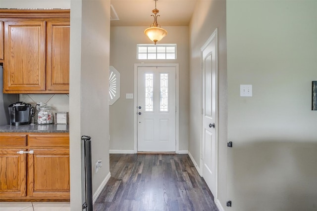 entryway featuring baseboards and dark wood-style flooring
