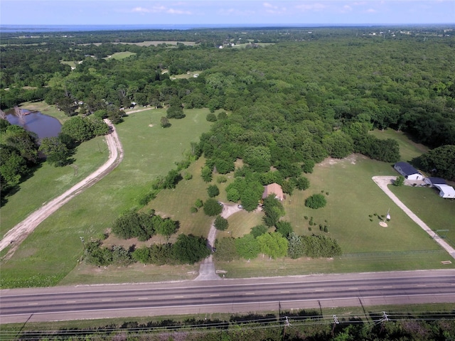 aerial view featuring a view of trees and a water view