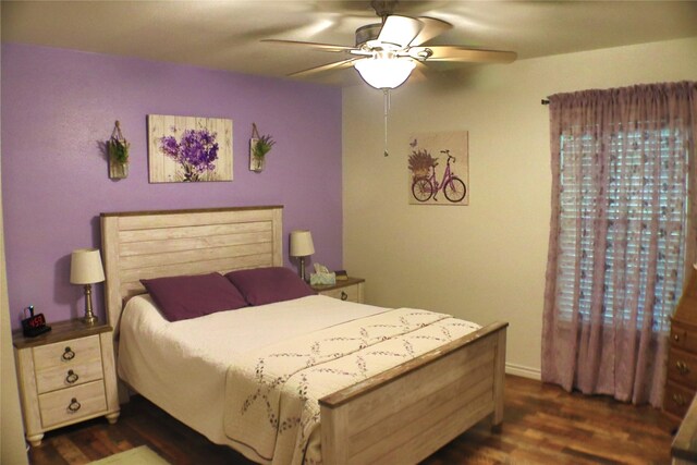 bedroom with ceiling fan and dark wood-type flooring