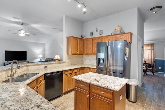 405 Londonderry Ln, Mansfield, TX 76063 - kitchen with light stone countertops, stainless steel refrigerator with ice dispenser, dishwasher, and a sink