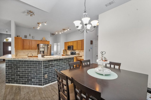 405 Londonderry Ln, Mansfield, TX 76063 - dining area featuring a notable chandelier, wood finished floors, and visible vents