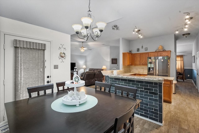 405 Londonderry Ln, Mansfield, TX 76063 - dining area with light wood finished floors and ceiling fan with notable chandelier