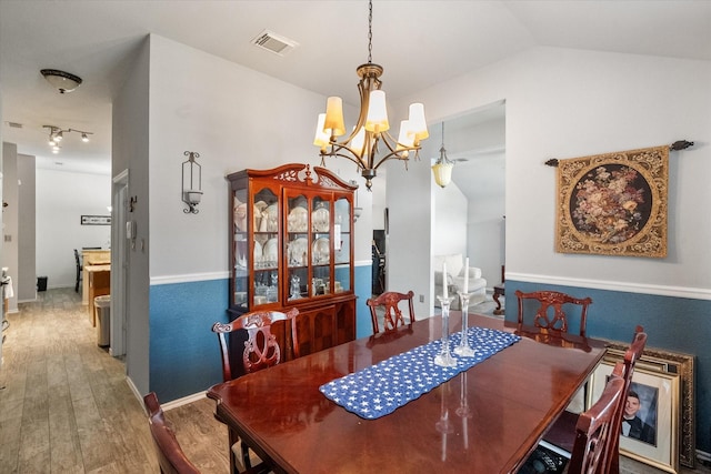 405 Londonderry Ln, Mansfield, TX 76063 - dining area with vaulted ceiling, an inviting chandelier, wood finished floors, and visible vents