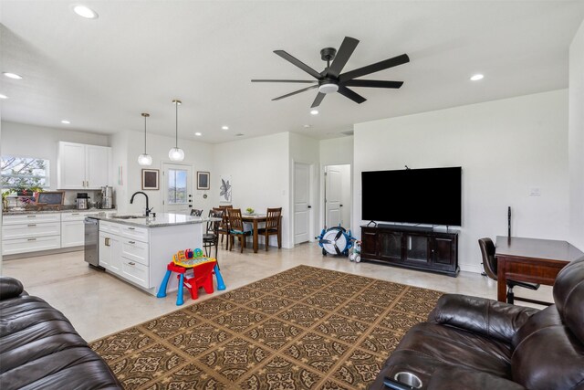 living area with a ceiling fan and recessed lighting