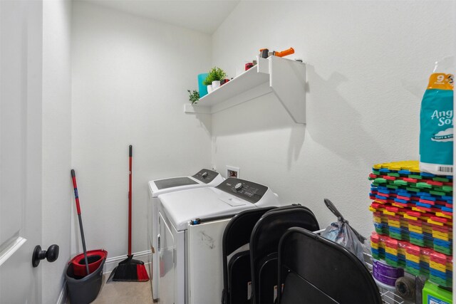 clothes washing area featuring washer and clothes dryer and laundry area