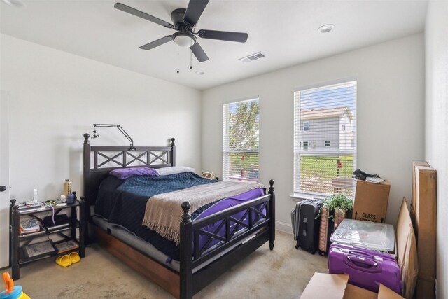 carpeted bedroom featuring ceiling fan, baseboards, and visible vents