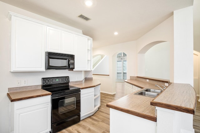 kitchen featuring open shelves, a sink, black appliances, light wood finished floors, and white cabinets
