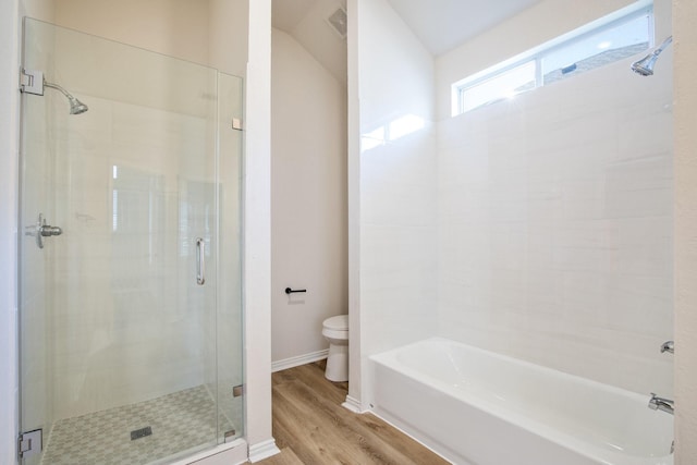 full bathroom with a shower stall, wood finished floors, toilet, baseboards, and a tub