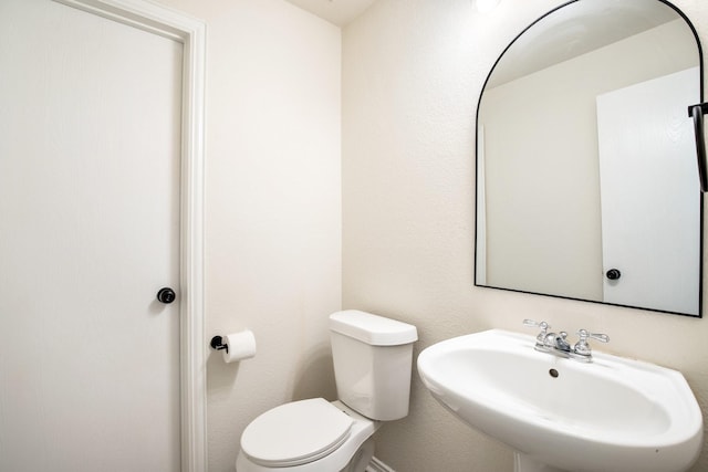 bathroom with toilet and a sink