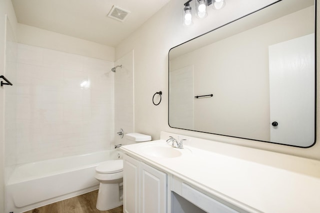 full bath with washtub / shower combination, wood finished floors, visible vents, toilet, and vanity