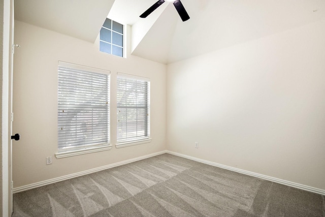 carpeted spare room featuring baseboards, high vaulted ceiling, and ceiling fan