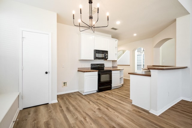 kitchen featuring white cabinets, light wood-style flooring, visible vents, an inviting chandelier, and black appliances