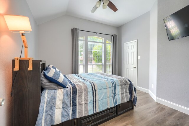 bedroom with lofted ceiling, wood finished floors, ceiling fan, and baseboards