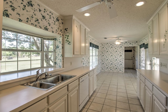 kitchen with dishwasher, ceiling fan, a sink, and wallpapered walls