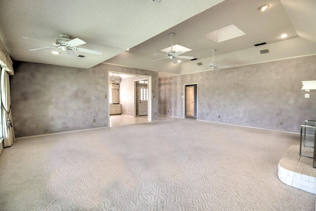 unfurnished living room with a textured ceiling, ceiling fan, light carpet, baseboards, and recessed lighting