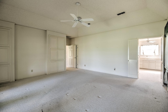 unfurnished bedroom with light carpet, visible vents, and connected bathroom
