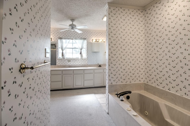 bathroom with a textured ceiling, wallpapered walls, a ceiling fan, a jetted tub, and ornamental molding