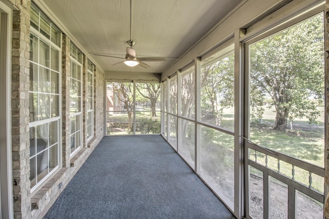 unfurnished sunroom with a ceiling fan