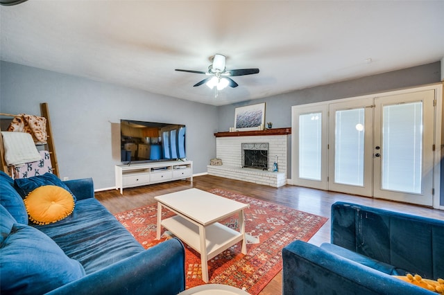 5601 Tucker St, The Colony, TX 75056 - living area featuring a ceiling fan, wood finished floors, baseboards, and a brick fireplace