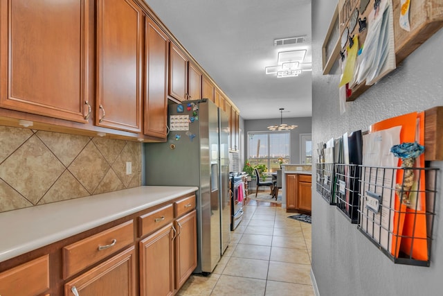 kitchen featuring light countertops, tasteful backsplash, visible vents, and stainless steel appliances