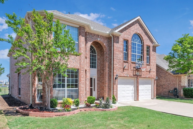 view of front of property with a front lawn, driveway, a shingled roof, a garage, and brick siding