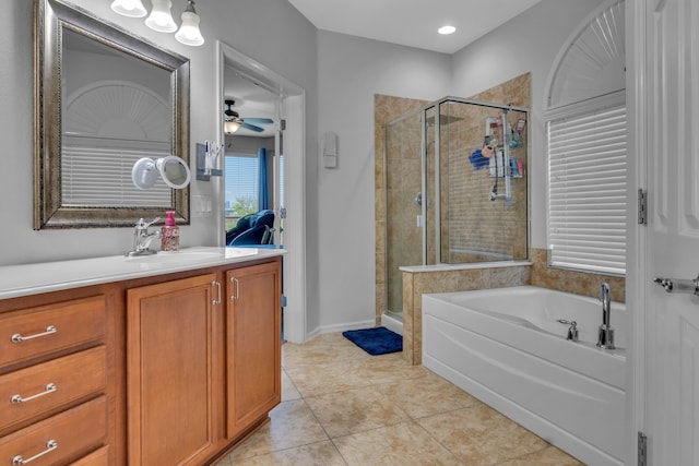 bathroom featuring a ceiling fan, a stall shower, a bath, vanity, and tile patterned flooring
