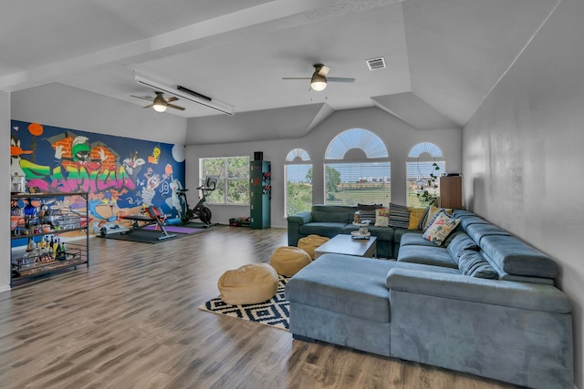 living area featuring vaulted ceiling, a ceiling fan, wood finished floors, and visible vents
