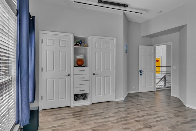 interior space featuring baseboards and wood finished floors