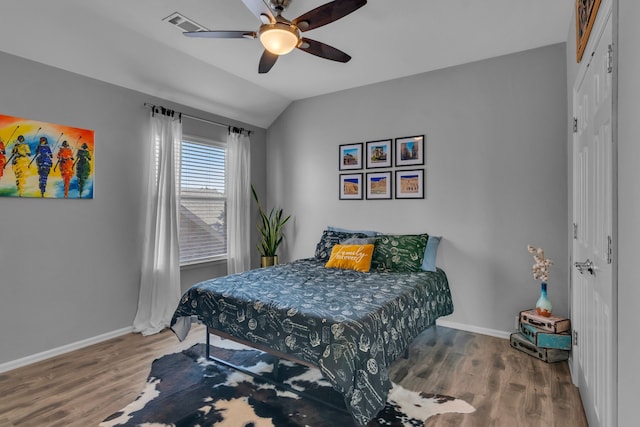 bedroom featuring wood finished floors, a closet, and baseboards