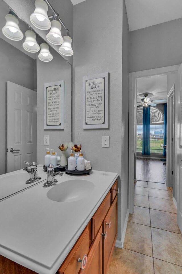 bathroom with vanity, ceiling fan, baseboards, and tile patterned flooring