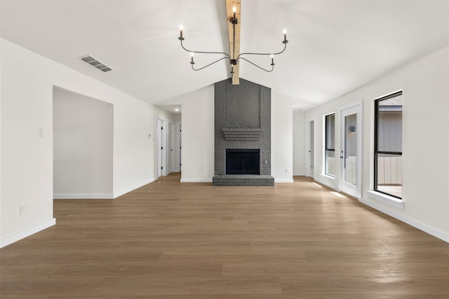 4524 Boston Dr, Plano, TX 75093 - unfurnished living room with an inviting chandelier, vaulted ceiling with beams, wood finished floors, and visible vents